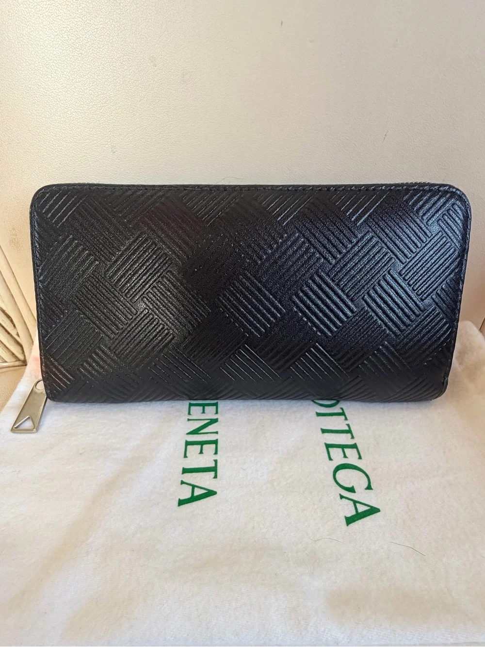 BOTTEGA VENETA Black Zip Around Wallet in Intrecciato Debossed Calfskin. UNISEX.